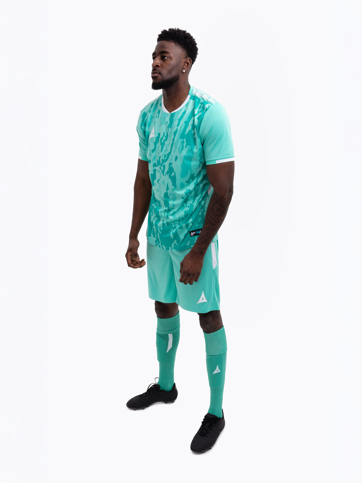 a man wearing an all mint green / hyper green football kit