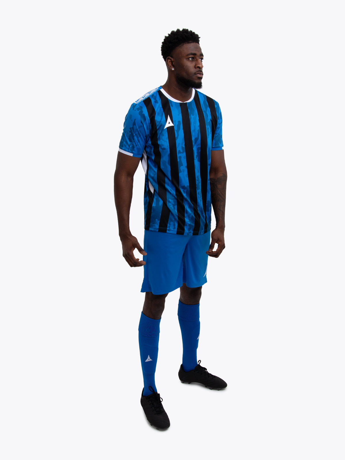 a model standing up wearing a royal blue and black football shirt, royal blue shorts and royal bluefootball socks.